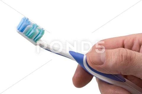 Toothbrush in hand Stock Photos