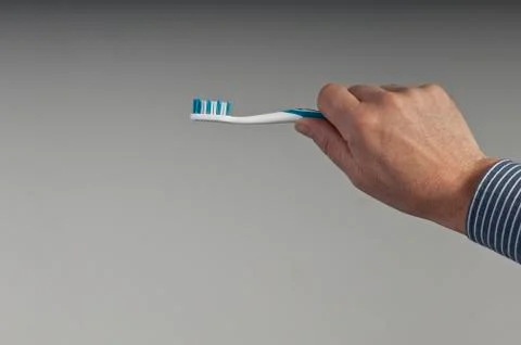  toothbrush in hand Stock Photos