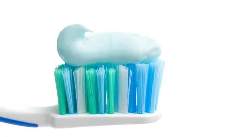 Toothbrush head with toothpaste, close-up view, isolated on white background, Stock Photos