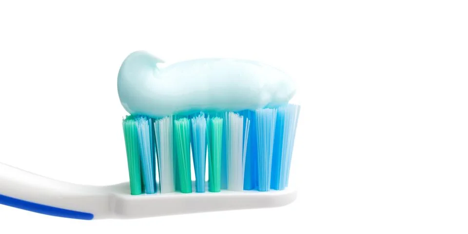 Toothbrush head with toothpaste, close-up view, isolated on white background, Stock Photos