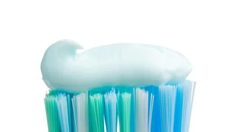 Toothbrush head with toothpaste, close-up view, isolated on white background, Stock-Fotos