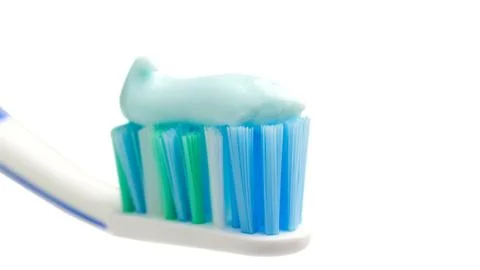 Toothbrush head with toothpaste, close-up view, isolated on white background, Stock Photos