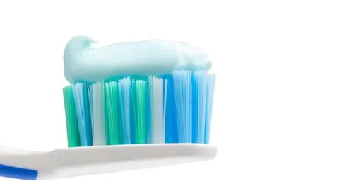 Toothbrush head with toothpaste, close-up view, isolated on white background, Stock Photos