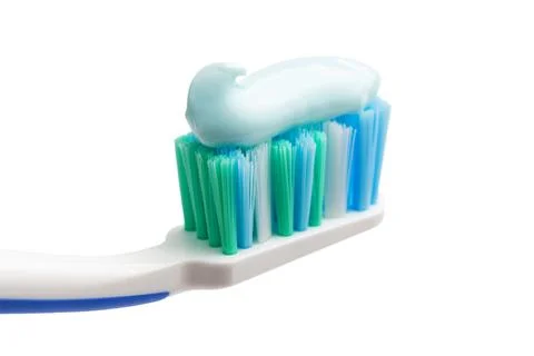 Toothbrush head with toothpaste, close-up view, isolated on white background, Stock Photos