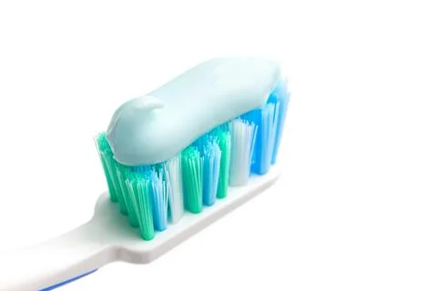 Toothbrush head with toothpaste, close-up view, isolated on white background, Stock Photos