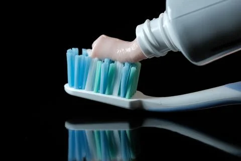 Toothbrush with light pink toothpaste Foto stock