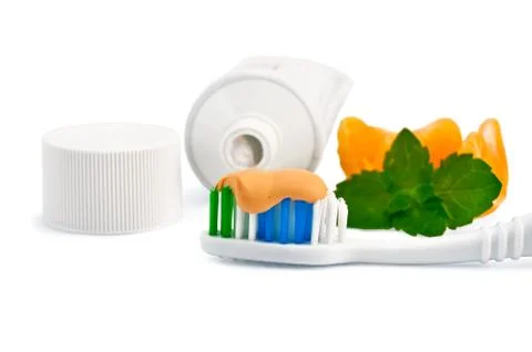 Toothbrush with orange toothpaste and orange slices 스톡 사진