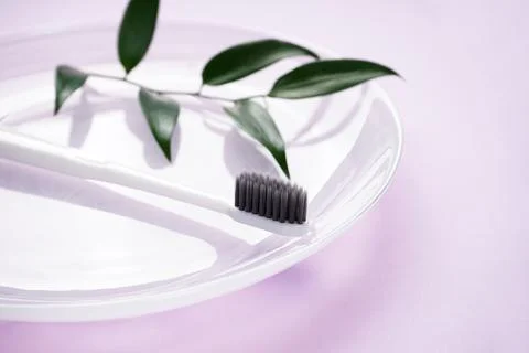 Toothbrush on a pink background close-up, flat lay composition. Stock Photos