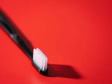 Toothbrush on a red background Stock Photos