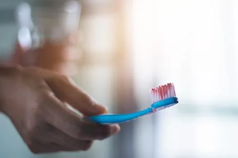 Toothbrush with scurvy in a bubble toothpaste on the bathroom background Fotos de archivo