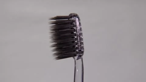 A toothbrush with soft bristles displayed against a clean white background. Stock Footage 313988356