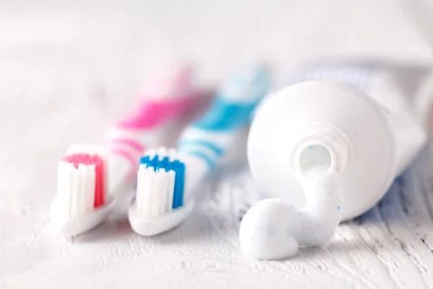 Toothbrush on the table with toothpaste and toothpaste tube Stock Photos