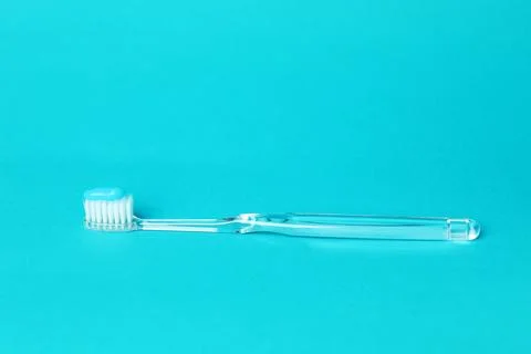 Toothbrush with toothpaste in air on light blue background Stock Photos