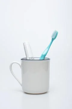Toothbrush, toothpaste and cup Stock Photos