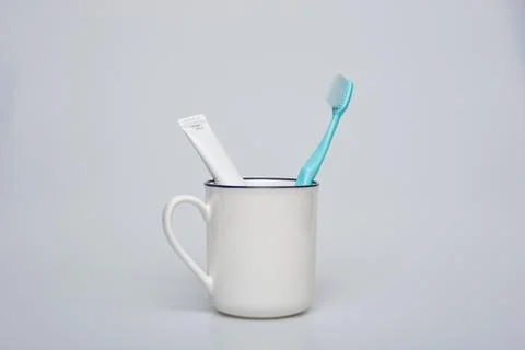 Toothbrush, toothpaste and cup Stock Photos