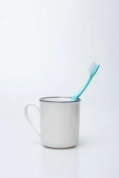 Toothbrush, toothpaste and cup Stock Photos