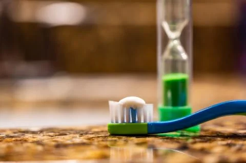 Toothbrush, toothpaste and sand timer for kids learning to slow down while br Stock Photos