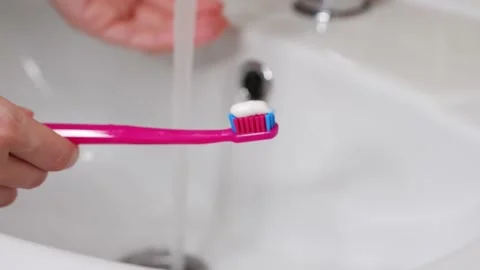 Toothbrush with toothpaste and sink with included water. Teeth cleaning. Stock Footage 164914922