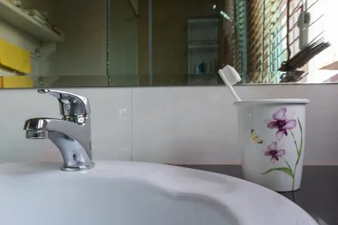 Toothbrush toothpaste bath glass closeup morning basin Stock Photos