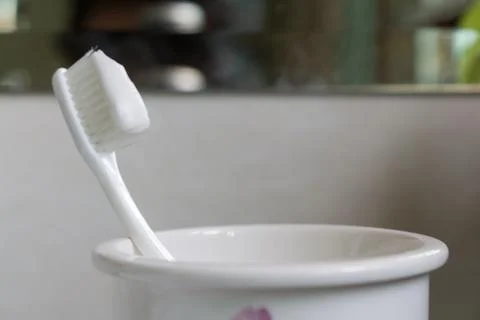 Toothbrush toothpaste bath glass closeup morning Stock Photos
