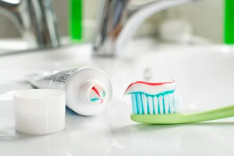 Toothbrush with toothpaste in the bathroom. Stock Photos