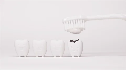 Toothbrush with Toothpaste brushing on Decayed Teeth model and Happy Tooth Stock Footage 103355072