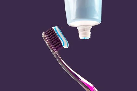 Toothbrush with toothpaste for cleaning teeth on a dark background. health ca Stock Photos