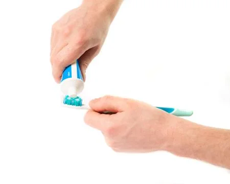 Toothbrush with toothpaste in the hand Stock Photos