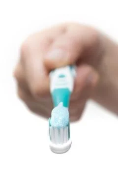 Toothbrush with toothpaste in the hand Stock Photos