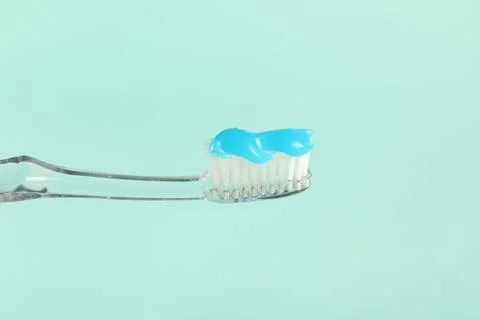 Toothbrush with toothpaste on light blue background, closeup Stock Photos