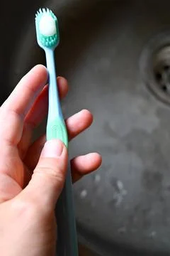 A toothbrush with the toothpaste  Stock Photos
