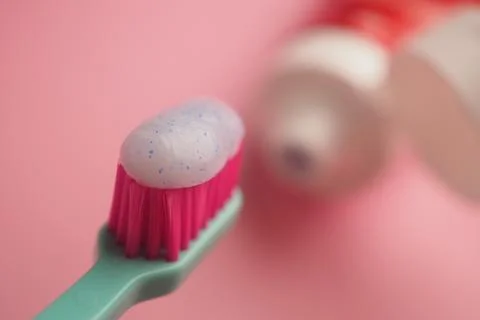 Toothbrush with toothpaste on a pink background Stock Photos