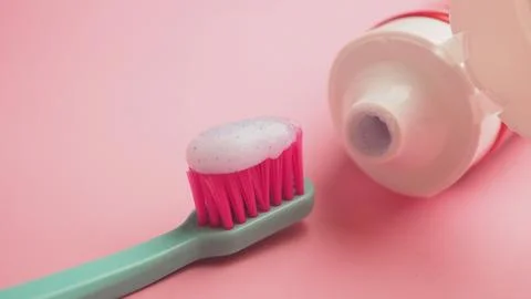Toothbrush with toothpaste on a pink background Stock Photos