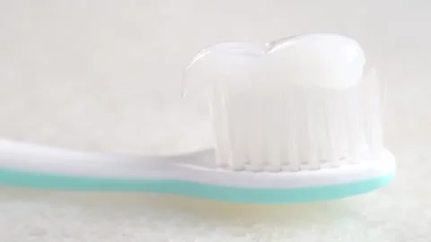 Toothbrush with toothpaste is placed on the bathroom sink. Stock Footage 284420615