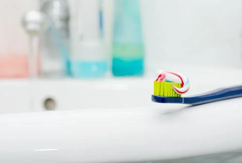 Toothbrush with toothpaste at the sink Stock Photos