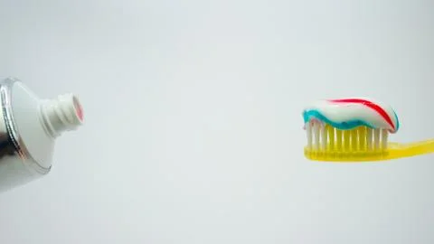 Toothbrush with toothpaste on a white background Stock Photos