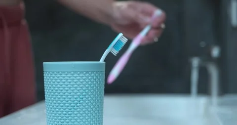 Toothbrush under flowing water ensuring effective cleanliness Essential care for Stock Footage 265728385