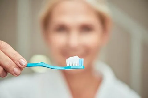 Toothbrush with white paste in hand Foto stock