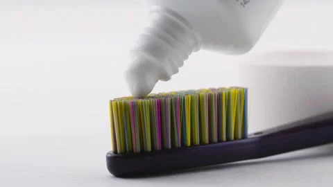 Toothbrush with white toothpaste on white background. Video stock 255482781