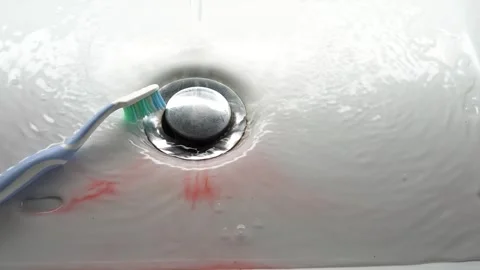 Toothbrush in a white washbasin with blood. Problem with gums. Stock Footage 248156970