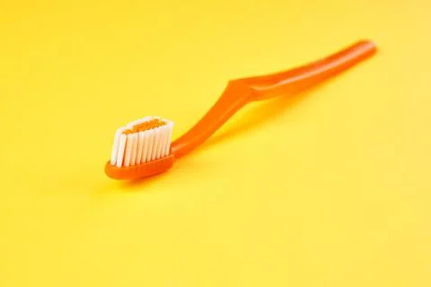 Toothbrush on yellow background close up. 스톡 사진