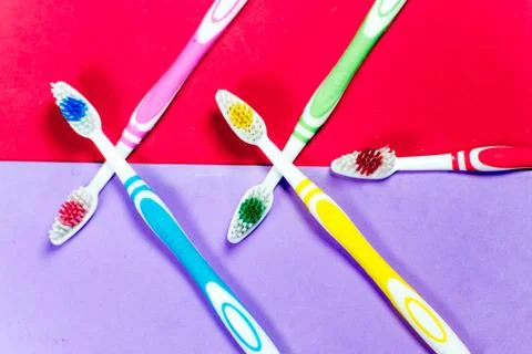 Toothbrushes and a toothpaste on a colorful background Stock Photos