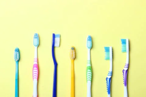 Toothbrushes on a colored background top view. Oral hygiene. Photos