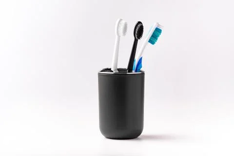 Toothbrushes in a Cup on a white background Stock Photos