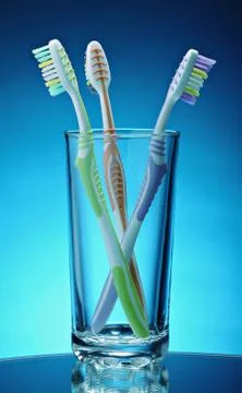 Toothbrushes in a glass Stock Photos