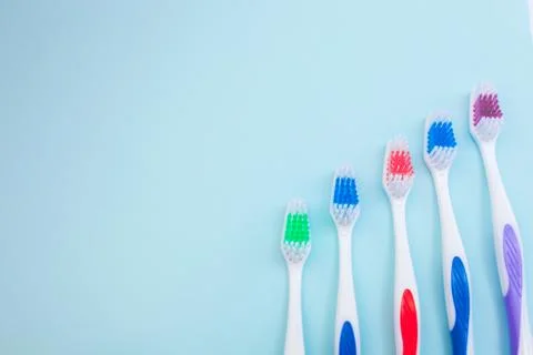Toothbrushes on light blue background, close up different kinds of Toothbrush Stock Photos