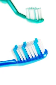 Toothbrushes over white background Stock Photos