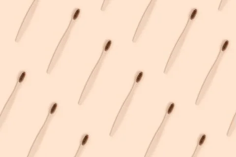 Toothbrushes pattern on a beige background. Stock Photos