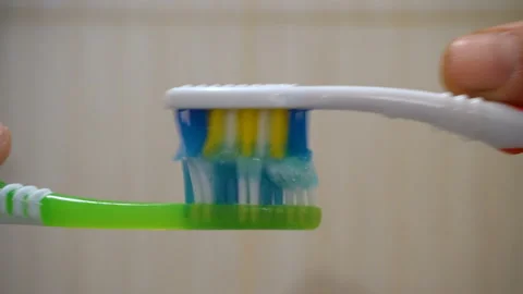 Toothbrushes rub against each other 4K Stock Footage 147894891