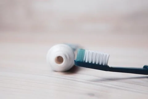 Toothpaste and brush on the table Stock Photos